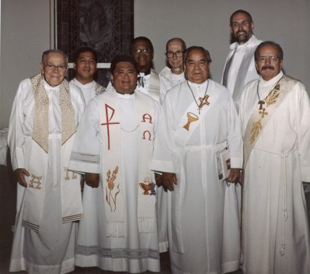 A group of men in white robes and ties.
