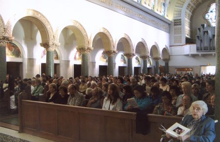 A large crowd of people in an old church.