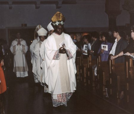 A group of people in white robes and hats.