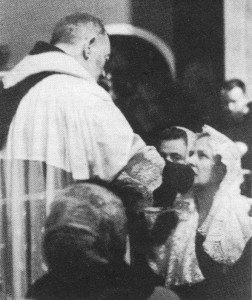 Lina Fiorellini receiving Holy Communion from Padre Pio