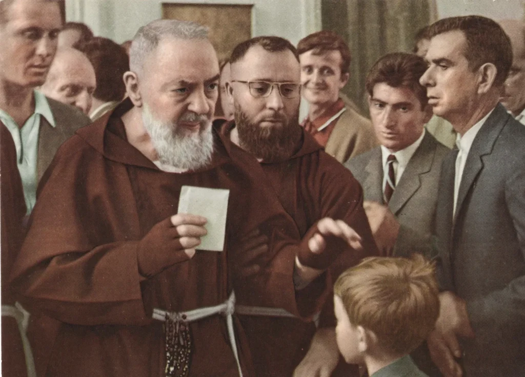 Friar blessing young boy amid onlookers