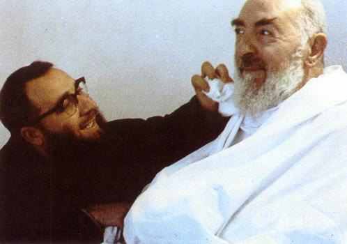 A man is shaving another man 's beard.