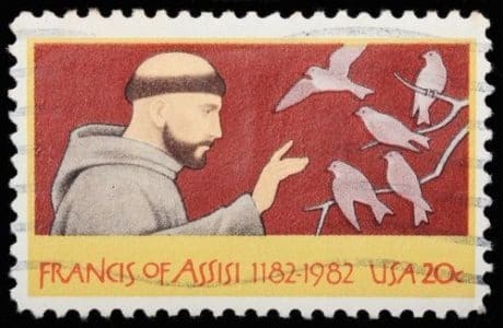 A stamp with a man and birds on it