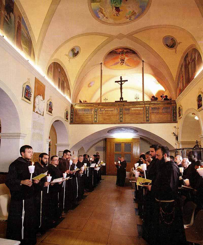 A group of people in black robes standing inside.