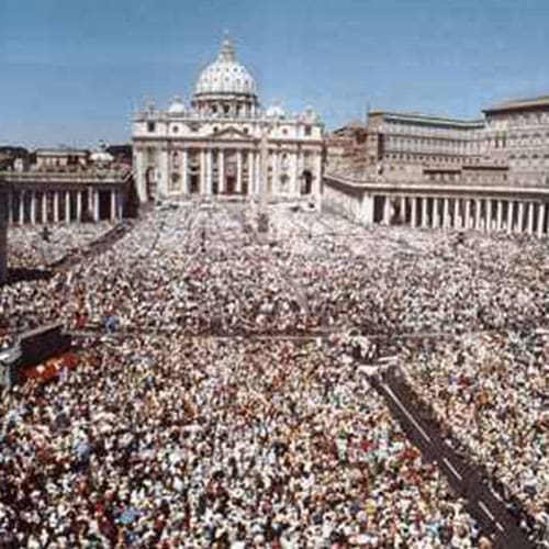 A large crowd of people gathered in front of the vatican.