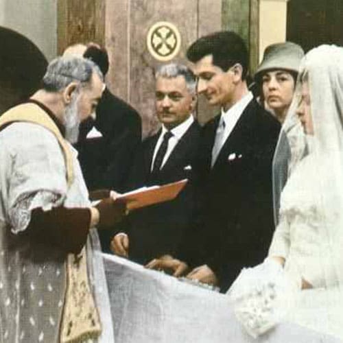 A priest is holding the bible as people look on.
