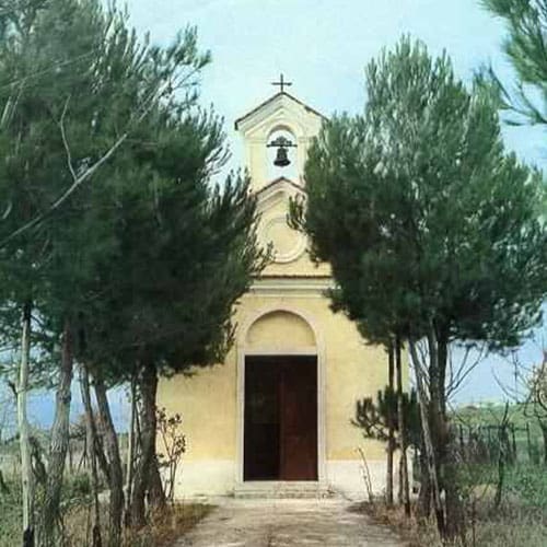 A small church with trees in the background