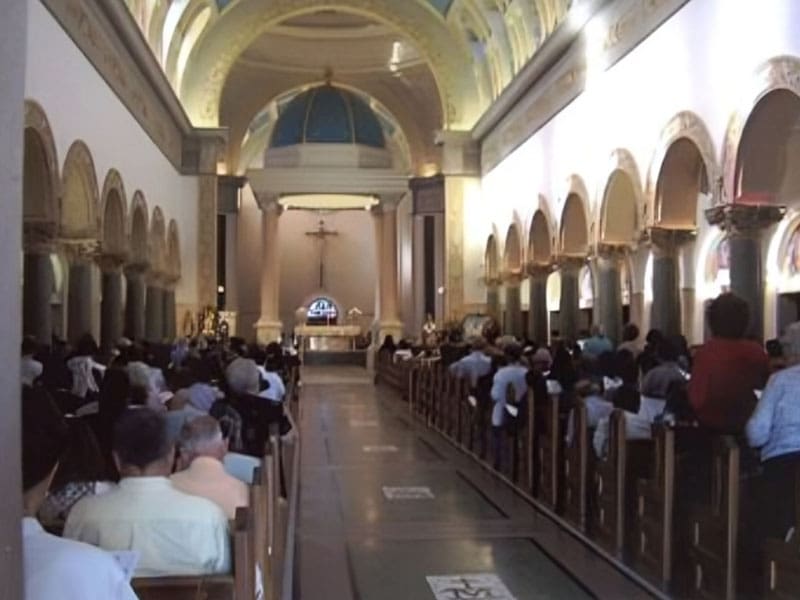 A church filled with people sitting in pews.