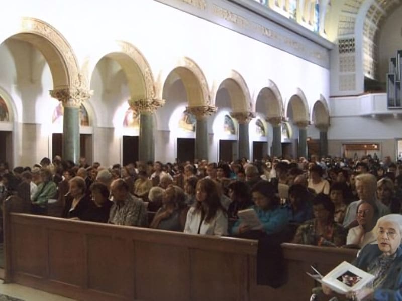 A large crowd of people in an indoor area.