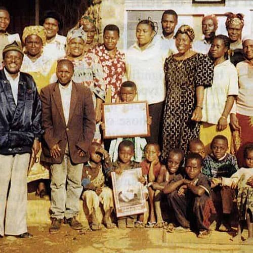 A group of people standing around each other.