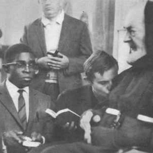 A group of men sitting around each other.