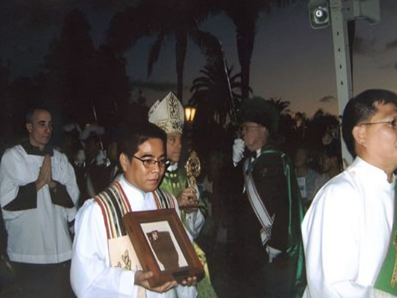 A man holding a plaque in front of people.