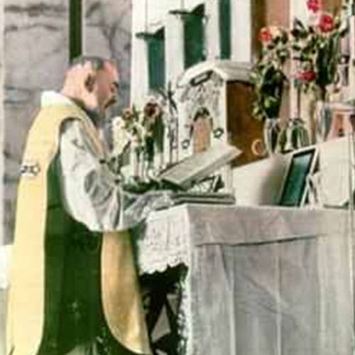 A priest is standing at the altar reading.