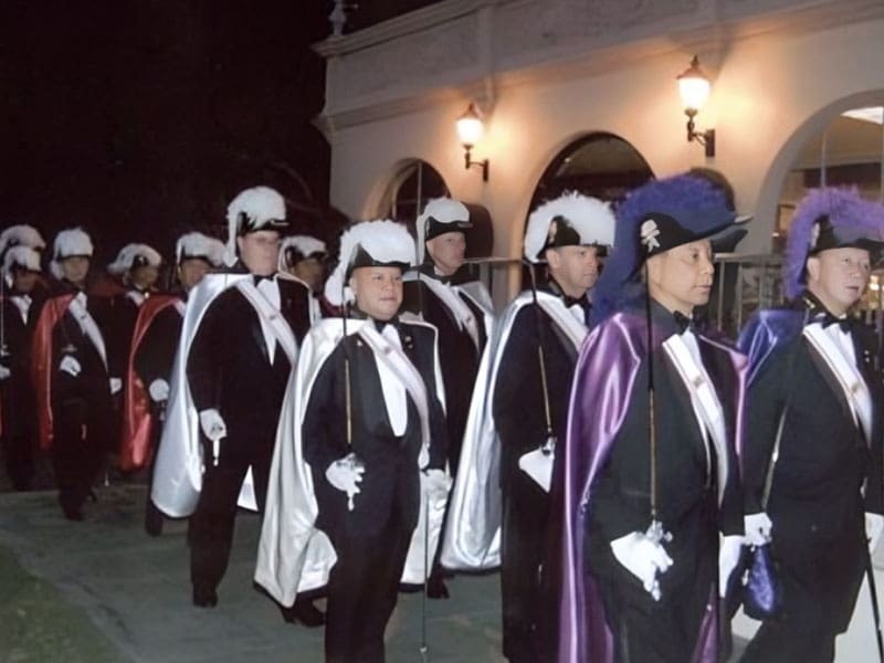 A group of men in suits and hats standing next to each other.