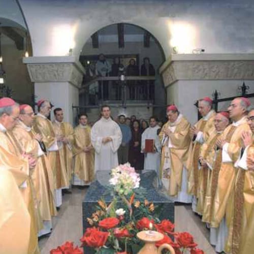 A group of men standing around a casket.