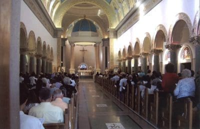 A church filled with people sitting in pews.