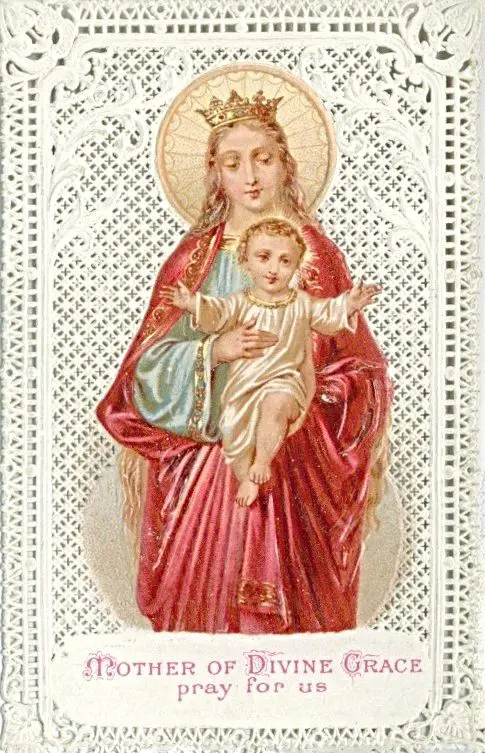 Mary holding baby Jesus in ornate frame.