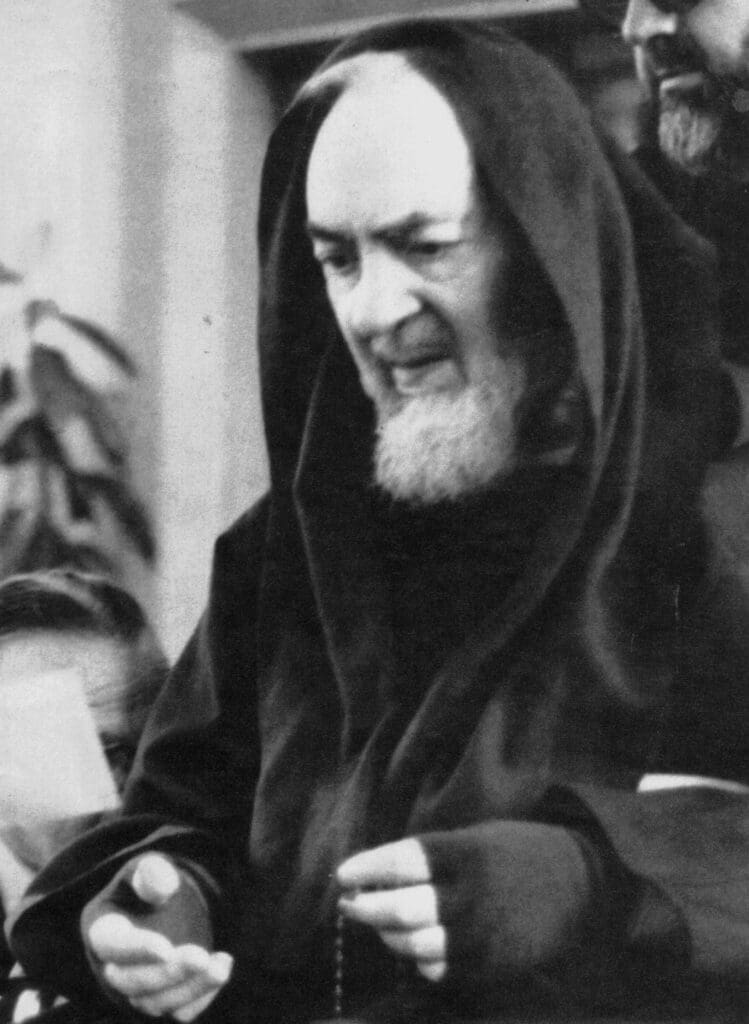 Monk in robes holding prayer beads.