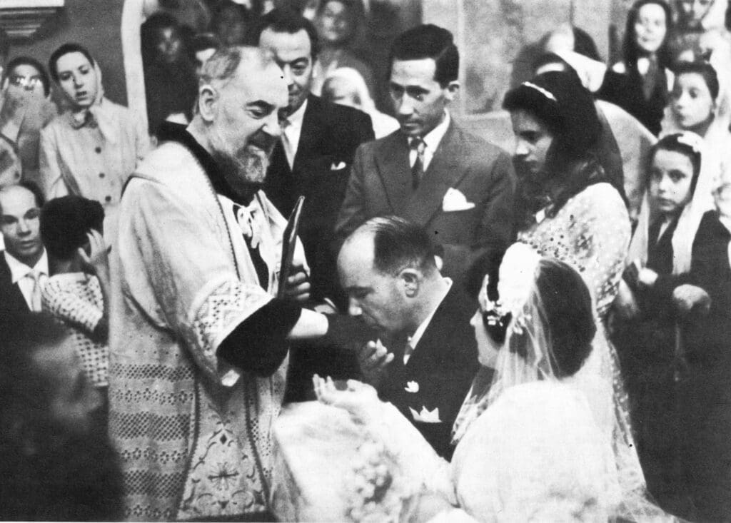 Priest blessing a couple at wedding ceremony.