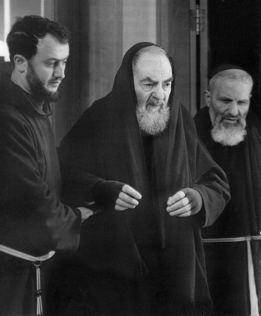 Three men in religious attire, walking together.